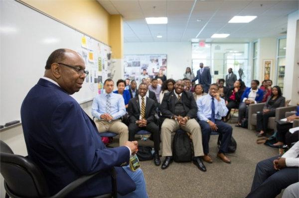 Bill Pickard seated in front and rows of students listening in the Multicultural Affairs office