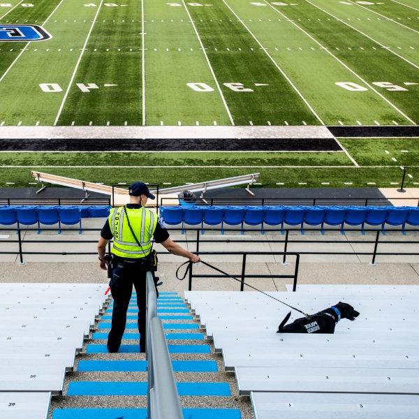 Koda, a K-9 explosives dog, walks the bleachers at Lubbers Stadium.