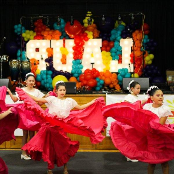 Four young girls dance at the Latin Americans United for Progres Fiesta Week 2023.